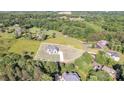 Aerial view of a home on a large lot surrounded by mature trees and landscaping at 1141 Harper Lee Dr, Newton, NC 28658