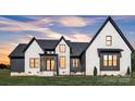 Stunning exterior elevation featuring a blend of modern design and neutral paint with black trim at 1141 Harper Lee Dr, Newton, NC 28658