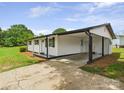 Home featuring a covered carport, with manicured mulch at 120 Hepler Rd, Taylorsville, NC 28681