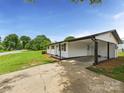 Home featuring a covered carport, leading to a back entry door at 120 Hepler Rd, Taylorsville, NC 28681