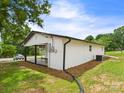 Home with vinyl siding, featuring a covered carport and manicured mulch at 120 Hepler Rd, Taylorsville, NC 28681