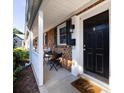 Welcoming front porch with a cozy seating area, classic brickwork, and a charming 'Hello' doormat at 1348 Green Oaks Ln # L, Charlotte, NC 28205