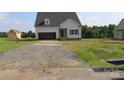 Classic single-Gathering home with gray siding and an attached garage, set within a spacious, unfinished lot at 145 Mason Tanner Ct, Rock Hill, SC 29730