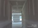 Bright hallway featuring neutral walls and ceilings, leading to an open room with natural light at 145 Mason Tanner Ct, Rock Hill, SC 29730