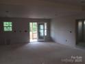 Open living space with natural light and access to an outdoor deck and backyard at 145 Mason Tanner Ct, Rock Hill, SC 29730
