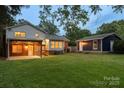 Spacious backyard with a covered patio, green lawn, and detached garage/shed at 15333 Catawba S Cir, Matthews, NC 28104