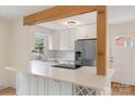 Modern kitchen with white cabinetry, stainless steel appliances, and bright white countertops at 15333 Catawba S Cir, Matthews, NC 28104
