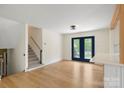Spacious living room features hardwood floors and stylish blue french doors at 15333 Catawba S Cir, Matthews, NC 28104