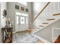 Bright foyer with soaring ceilings, staircase with wood treads, and stylish decor at 1655 Essex Hall Dr, Rock Hill, SC 29730