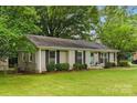 Well-maintained brick home with black shutters, a manicured lawn, and tasteful landscaping in a lush setting at 1700 Emerywood Dr, Charlotte, NC 28210
