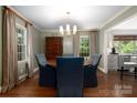 Elegant dining room featuring hardwood floors, and a stylish chandelier, adjacent to the kitchen at 2000 Ferncliff Rd, Charlotte, NC 28211