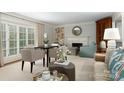 Bright living room with fireplace, neutral decor, and natural light from large windows at 2000 Ferncliff Rd, Charlotte, NC 28211
