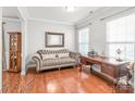 Cozy living room with hardwood floors, tufted sofa, and natural light from windows at 2441 Chatham Dr, Fort Mill, SC 29707