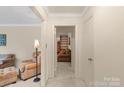 Bright living room featuring neutral walls, plush furniture, and an open doorway at 301 Museum Rd, Statesville, NC 28625