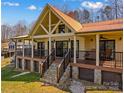 Charming exterior of the lake house with a metal roof, stone foundation, and inviting porch at 3062 Bass Dr, Sherrills Ford, NC 28673
