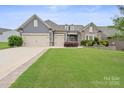 Inviting two-story home with a well-manicured lawn and a three car garage at 3537 Plum St, Fort Mill, SC 29715