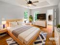 Tranquil bedroom with tray ceiling, hardwood floors, and ample natural light at 3600 Sipes Ln, Charlotte, NC 28269