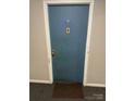 Apartment door with unit number, buzzer, peephole and welcome mat at 417 Orchard Trace Ln # 6, Charlotte, NC 28213