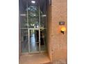 Close-up of building entrance with glass door, globe lighting fixtures and unit number at 417 Orchard Trace Ln # 6, Charlotte, NC 28213