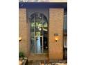 Building entrance with brick facade, glass doorway, unit number and globe lighting fixtures at 417 Orchard Trace Ln # 6, Charlotte, NC 28213