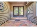Elegant double doors with brick entryway and decorative sidelight at 46 Timberidge Dr, Lake Wylie, SC 29710