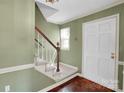 Inviting entryway featuring a staircase, hardwood floors, and a neutral color scheme at 4738 Truscott Rd, Charlotte, NC 28226