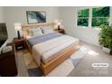 Cozy primary bedroom with a large window, stylish decor, and comfortable furnishings at 5013 Prestwick Ln, Charlotte, NC 28212