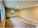 Bright living room with wood-look flooring and natural light at 509 North St, Belmont, NC 28012