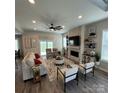 Bright living room featuring a stone fireplace, stylish furniture, and a sliding glass door for natural light at 5118 Regents Park Dr, Hickory, NC 28602