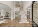 Bright foyer featuring high ceilings, hardwood floors, staircase, and open view to other rooms at 601 Carver Pond Ln, Waxhaw, NC 28173