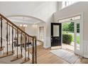 Inviting foyer with an open entryway, beautiful hardwood floors, staircase and a view of the dining room at 601 Carver Pond Ln, Waxhaw, NC 28173