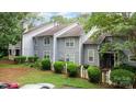Well-manicured lawn with a white picket fence frames this lovely home's exterior at 6011 Treetop Ct, Charlotte, NC 28212