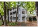 Three-story townhouse with multiple balconies and natural wooded surroundings at 6011 Treetop Ct, Charlotte, NC 28212