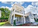 Beautifully designed two-story home with stone accents, a cozy balcony, and a well-maintained front yard at 6027 Veld Ct # 82, Charlotte, NC 28215