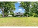 A charming home with a large yard and mature trees, including a covered parking area at 6362 Sherrills Ford Rd, Catawba, NC 28609
