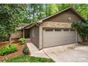 Charming home exterior featuring a stone facade, two-car garage, and well-maintained landscaping at 7 Turtle Ln, Clover, SC 29710