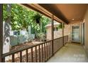 Covered porch showcasing stone accents, decorative hanging plants, and a tranquil outdoor retreat at 7 Turtle Ln, Clover, SC 29710