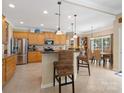 Well-equipped kitchen features stainless steel appliances, ample counter space, and bar stool seating at 7627 Woodcrest Dr, Stanley, NC 28164