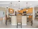 Bright and spacious kitchen boasts ample counter space, pendant lighting, and a functional layout at 7627 Woodcrest Dr, Stanley, NC 28164