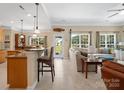 Open-concept living space offers a seamless transition from kitchen to Gathering room and outdoor access at 7627 Woodcrest Dr, Stanley, NC 28164