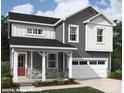 Charming two-story home featuring gray siding, stone accents, a covered porch, and an attached two-car garage at 9858 Quercus Ln, Huntersville, NC 28078
