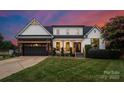 Charming two-story home featuring a covered front porch and well-manicured lawn at 120 Lakeshore Dr, Mooresville, NC 28117