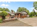 Backyard showcasing a brick home exterior, patio with swing, concrete, and gravel area at 124 Courtney Ln, Matthews, NC 28105