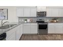 Modern kitchen with white cabinets, stainless steel appliances, and granite countertops, perfect for cooking at 129 Canada Dr # 85, Statesville, NC 28166
