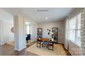 Stylish home office with shelves, desk, bright natural light, and decorative window treatments at 133 Way Cross Ln, Troutman, NC 28166