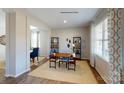 Stylish home office with shelves, desk, bright natural light, and decorative window treatments at 133 Way Cross Ln, Troutman, NC 28166
