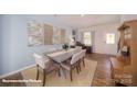 Bright dining space featuring a cozy rug, elegant table setting, and a view of the entryway at 136 Mary Locke Way, Statesville, NC 28677