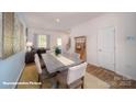 Well-lit dining area with a hardwood floor, modern furniture, and a view of the staircase at 136 Mary Locke Way, Statesville, NC 28677