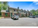 Townhome exterior featuring brick accents, red shutters, and a well-maintained parking area at 1485 20Th Ne Ave, Hickory, NC 28601