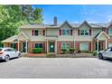 Townhome exterior featuring brick accents, red shutters, and a well-maintained parking area in daytime at 1485 20Th Ne Ave, Hickory, NC 28601